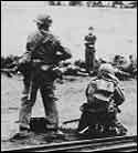 Machine gunner shoots captured Germans
